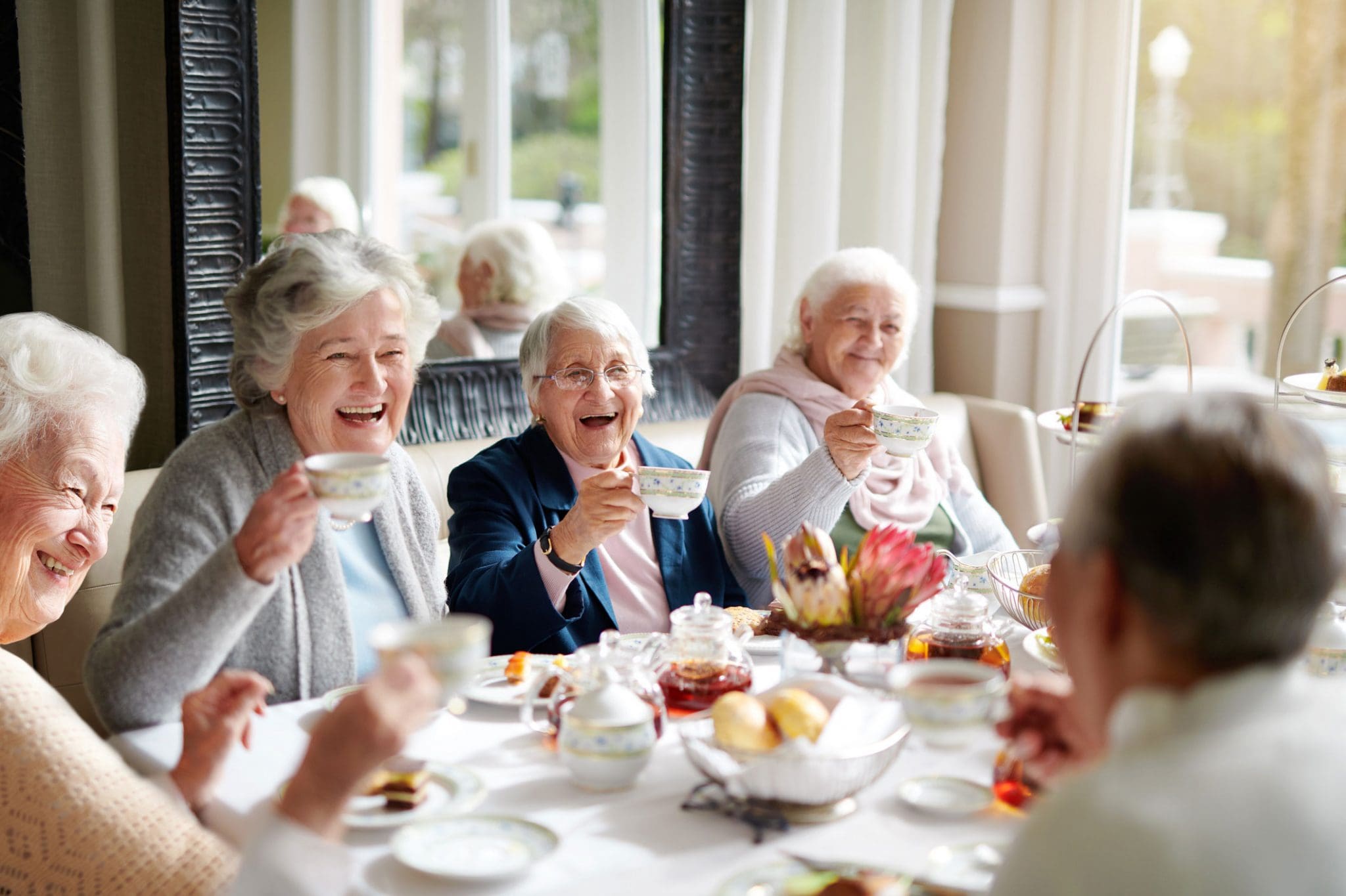 Older women smiling and drinking tea